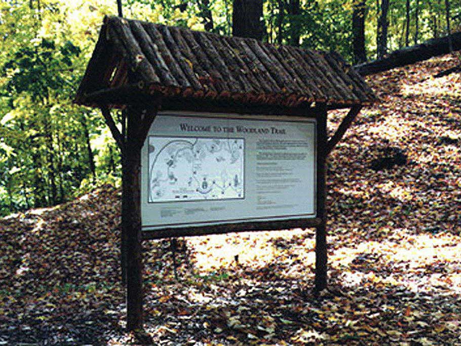 A kiosk built for a state park built with eastern red cedar trees and branches