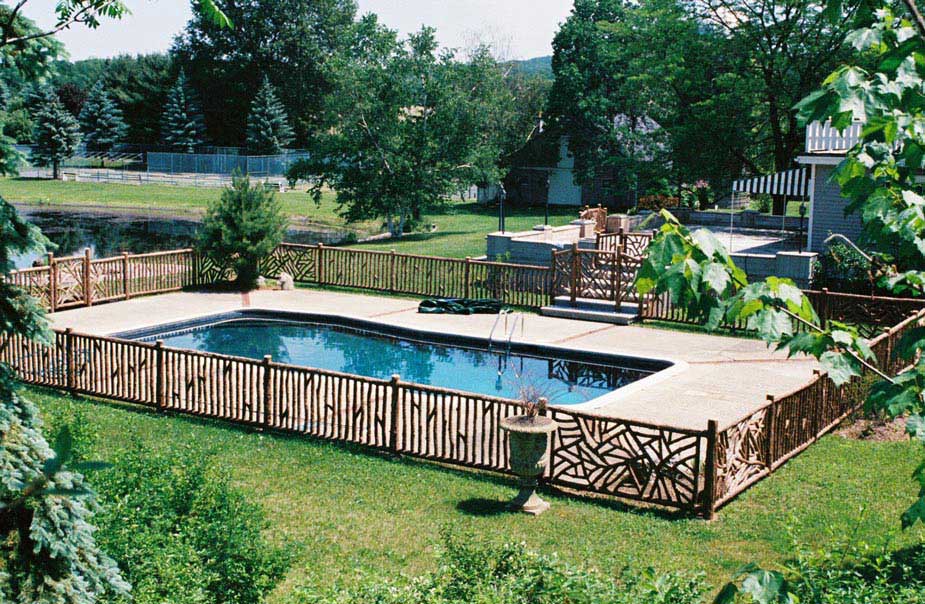 Pool fencing built in the rustic style using logs and branches titled Lewis Pool Enclosure