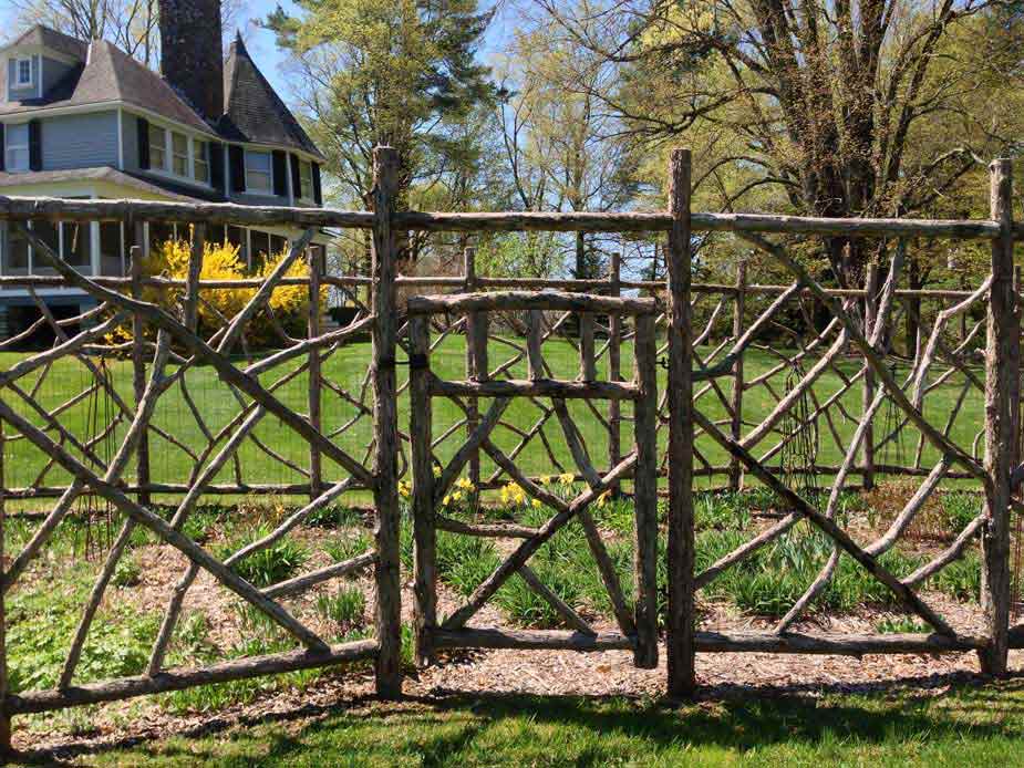 Rustic garden gate and fencing built using bark-on trees and branches titled Squire Gate