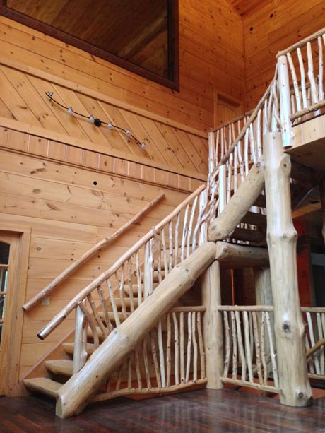 Interior stair railing built with eastern red cedar trees stripped of its bark